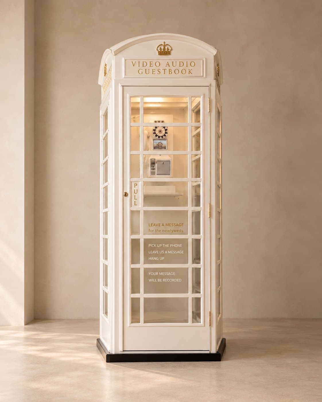 Cream vintage phone booth with gold crown and 'Video Audio Guest Book' sign, a retro telephone visible inside